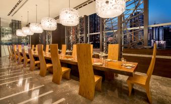 large windows, and features wooden tables and chairs, creating a well-lit and inviting dining space at Nina Hotel Tsuen Wan West