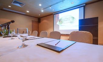 A conference room is equipped with a large table and chairs, specifically arranged for hosting events or social gatherings at Best Western Plus Hotel Hong Kong