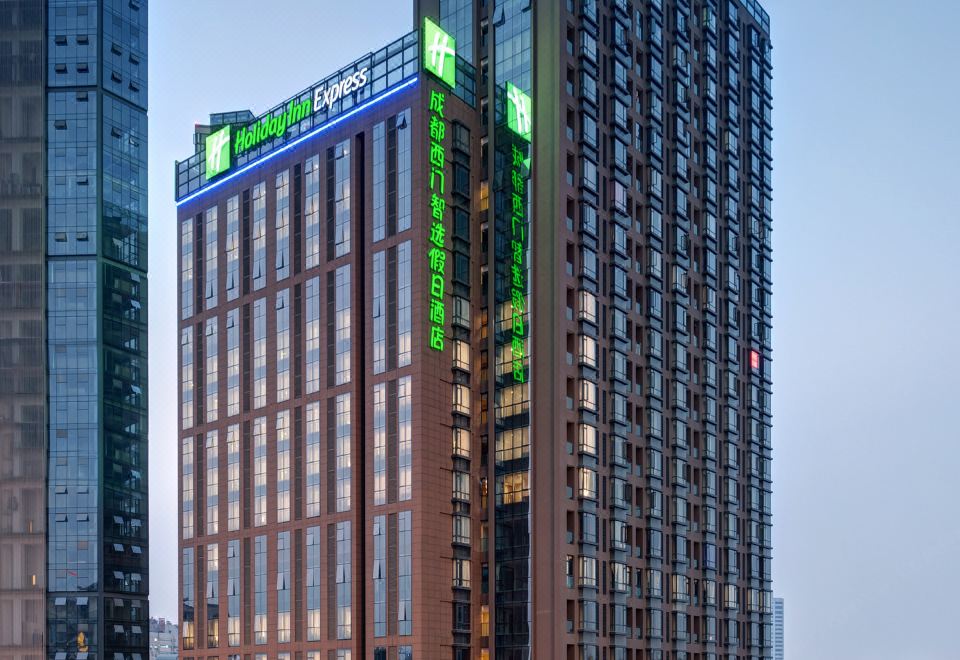 A large building with multiple windows on the side and one at the top in the front at Holiday Inn Express Chengdu West Gate