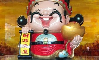 The hotel entrance featured a statue with an Asian character on top and another statue in the background with a European character on top at Hotel Fortuna