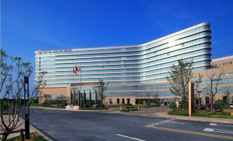 "There is a large building in front with an exterior view and the word ""hotel"" displayed on top" at Grand Square Hotel Wuhu