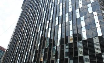 The reflection of a building in an urban area, also known as a person's reflection at Hotel Midtown Richardson