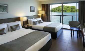 a hotel room with two beds , one on the left and one on the right side of the room at Novotel Suva Lami Bay