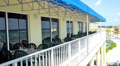 a balcony with a blue tarp over it , providing shade and protection from the elements at Wyndham Reef Resort Grand Cayman