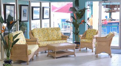 a living room with a couch , chairs , and coffee table in front of a window at Wyndham Reef Resort Grand Cayman