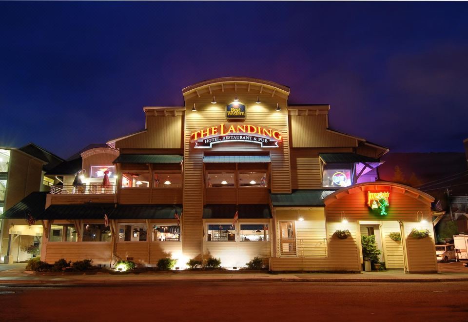 "a building with a sign that says "" the landing "" is lit up at night" at The Landing Hotel