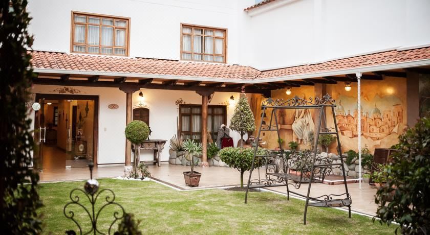 a beautiful courtyard with a gazebo surrounded by lush greenery , creating a serene and inviting atmosphere at San Juan Hotel