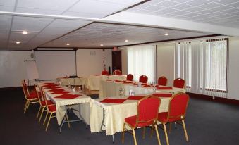 a large conference room with multiple tables and chairs , all set up for a meeting at Causeway Bay Hotel