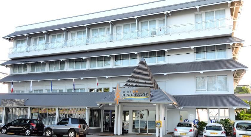 "a three - story building with a sign that reads "" hotel le beaurivage "" prominently displayed on the front" at Hotel Beaurivage