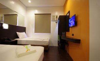 a modern hotel room with two beds , a flat screen tv , and orange walls , all decorated in white and brown at Yhotel