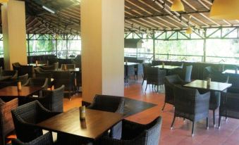 a large dining area with several tables and chairs , some of which are empty and others are empty at Tasik Ria Resort