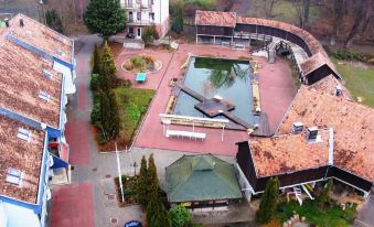 an aerial view of a courtyard with a fountain surrounded by buildings , including a building with a green roof at Waterfront
