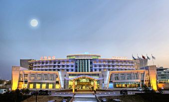 "There is a large building with the word ""hotel"" on the front and another building behind it" at Tianyuan Hotel