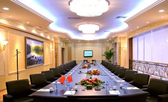 There is a spacious conference room available for meetings or special occasions, furnished with a long table and chairs at Tianyuan Hotel