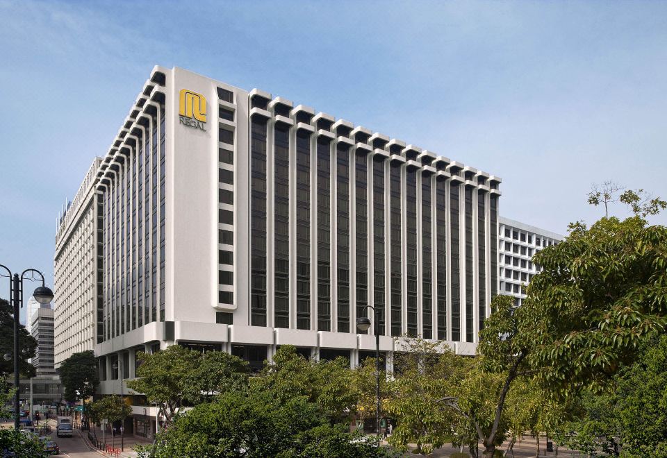 "A large white building with trees in front and the word ""hotel"" on its side" at Regal Kowloon Hotel