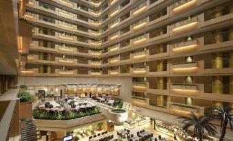 An aerial view reveals the lobby and restaurant of a multi-story building at The Royal Garden Hotel