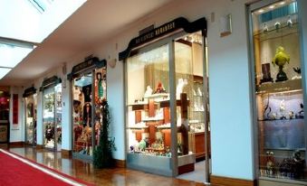 The store's front window displays a wide variety of items, including an open doorway at The Grand Hotel