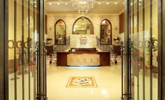 a grand entrance with two doors , a chandelier , and a large chandelier hanging from the ceiling at Huis Ten Bosch